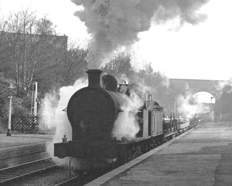 Ex-LNWR 0-8-0 No 49381 runs through the up platform after passing under Anchorage Road bridge on 7th March 1964