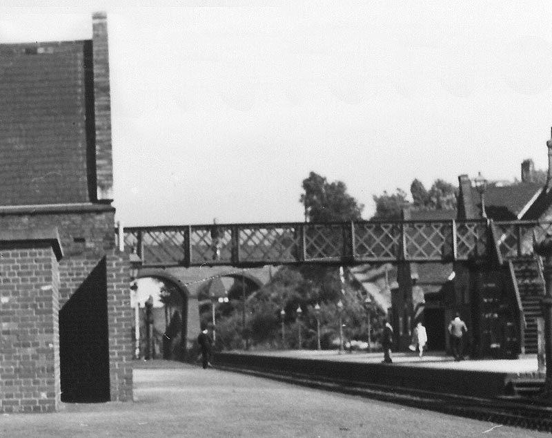 Close up showing the entrance to the Gentlemen's toilet on the left and the footbridge steps on the up platform