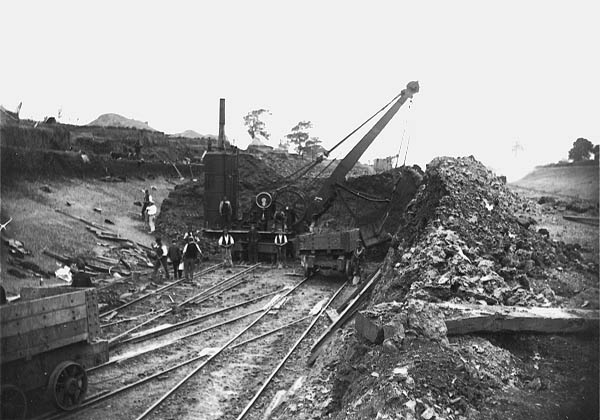 A steam powered navvy, built by Whitaker & Sons of Leeds, is seen working in a deep cutting near Rugby