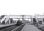 An unidentified ex-LMS 4-6-0 'Black Five' is seen at the head of a down express service emanating from the south