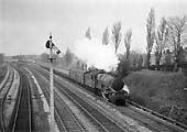 British Railways built 4-6-0 No 7008 'Swansea Castle' approaches Woodcock Lane bridge at the head of an up express
