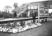 Looking across from the relief island platform to the main island platform showing the floral display beds with the original covered footbridge in the background