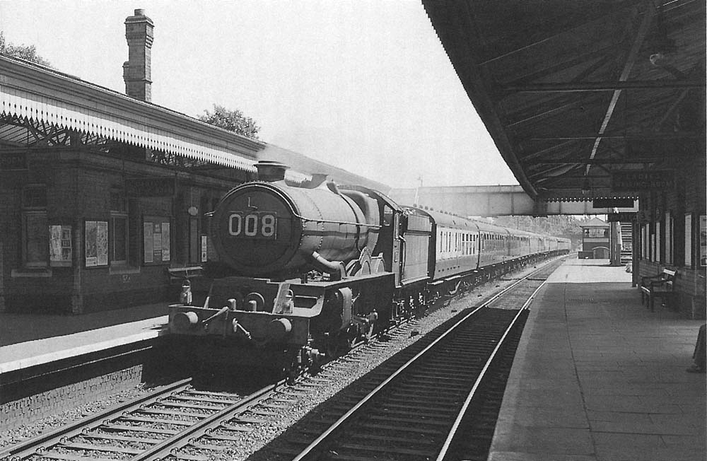 Ex-GWR 4-6-0 No 6017 'King Edward IV' passes through the station on the down main on 4 th July 1959 with the 11:10am Paddington to Birkenhead (Woodside) service