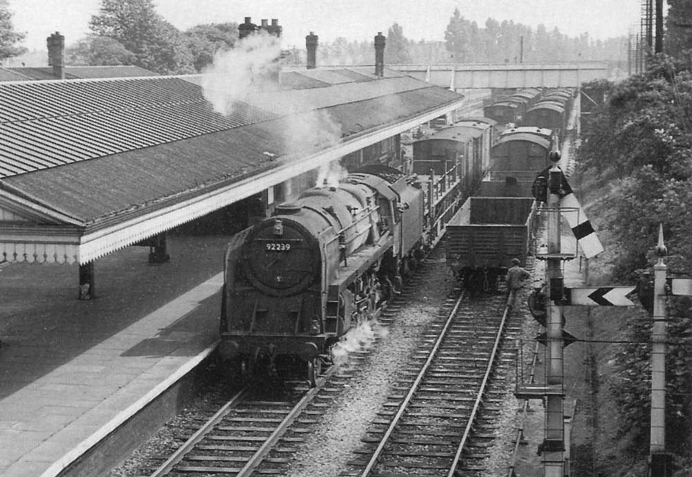 British Railways 2-10-0 Standard Class 9F No 92239 is seen heading a mixed freight service on the down relief line on 7th September 1960