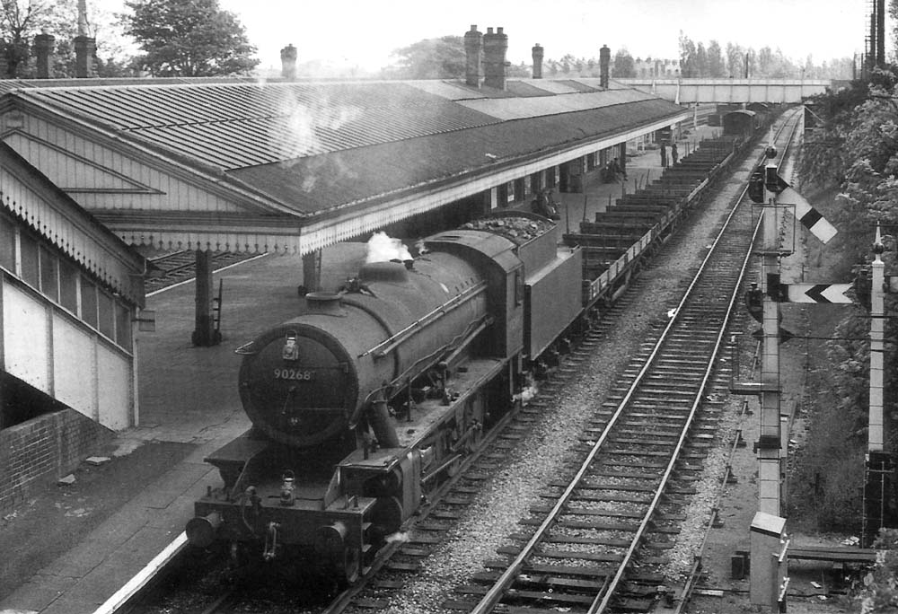 Ex-WD 2-8-0 No 90268 is seen heading an unfitted freight through the station on the down relief lines on 8th May 1961