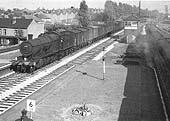 Ex-GWR 2-8-0 28xx Class No 2818 is seen with a fitted freight passing through the station's down main line