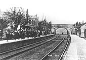 View of the down platform which is full of passengers waiting for a local passenger train to Snow Hill