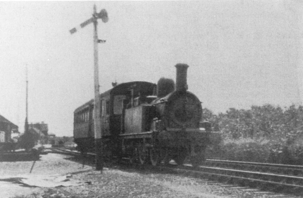 An unidentified Great Western 517 class 0-4-2T propels a auto trailer from Bearley into Alcester Station