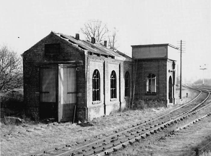 View of the derelict shed adjacent to Alcester Junction with the wooden doors and water tank still retaining the distinctive GWR painting policy