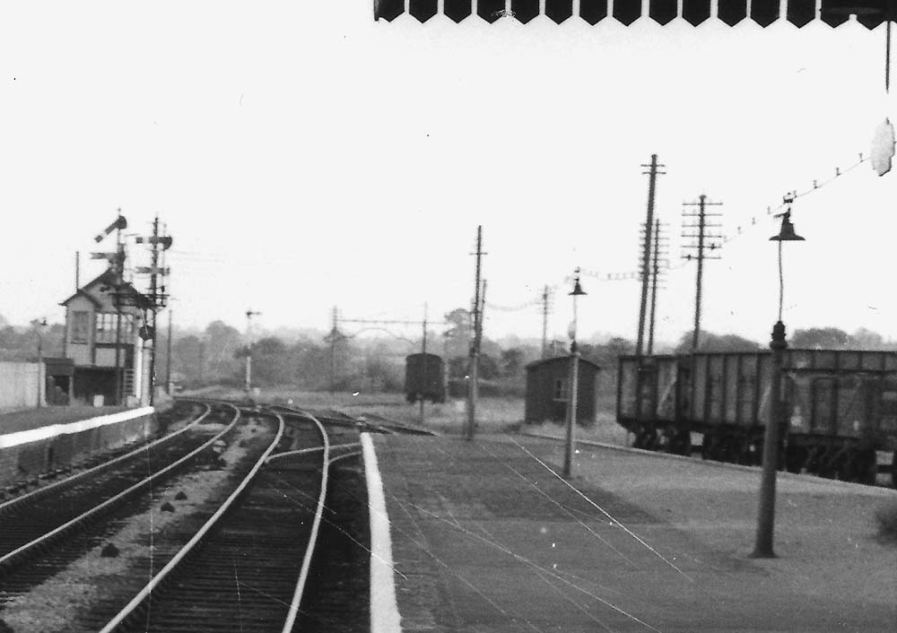 Close up showing Bearley East Junction Signal Box and the signal gantry controlling the line to Stratford on Avon and the north curve
