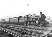 GWR 4-6-0 'Saint' class No 2903 'Lady of Lyons' on an Up express about to cross Bentley Heath Level Crossing
