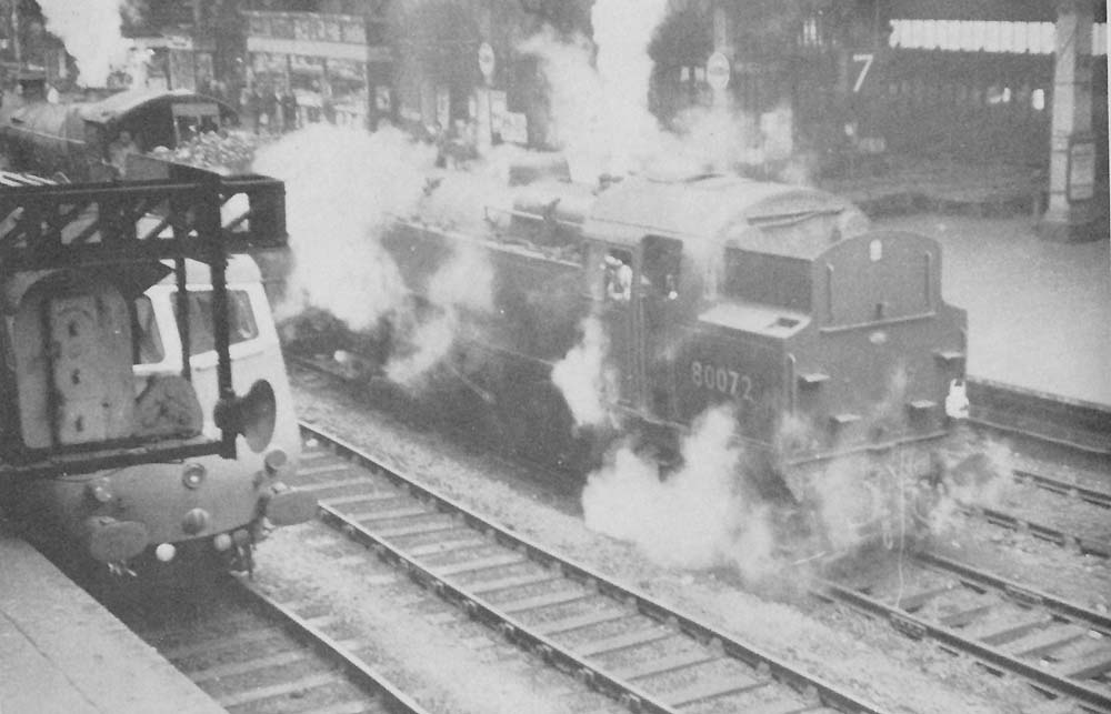 British Railways 2-6-4T Standard Class 4 No 80072 is seen with an unidentified ex-GWR Manor class locomotive standing on the down through line in the 1960s