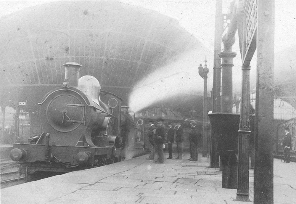 A pair of unknown GWR 4-2-2 'Achilles' class locomotives are seen at the head of a down express for Wolverhampton at the North end of Snow Hill