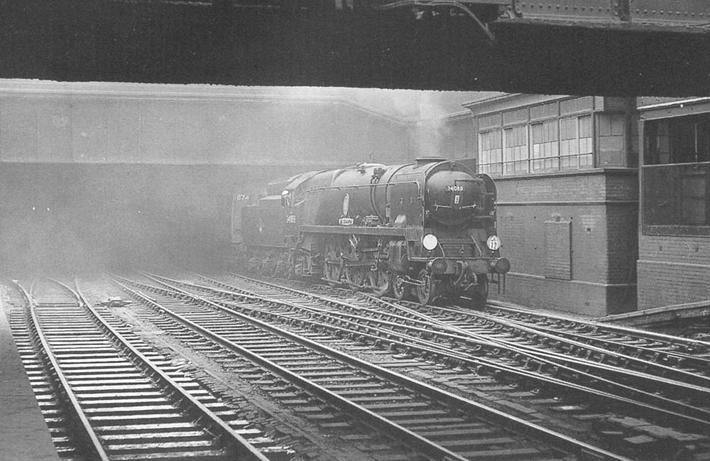 British Railways built 4-6-2 Rebuilt Battle of Britain class No 34088 '213 Squadron' is seen emerging from the gloom of Snow Hill tunnel and passing Snow Hill South Signal Box