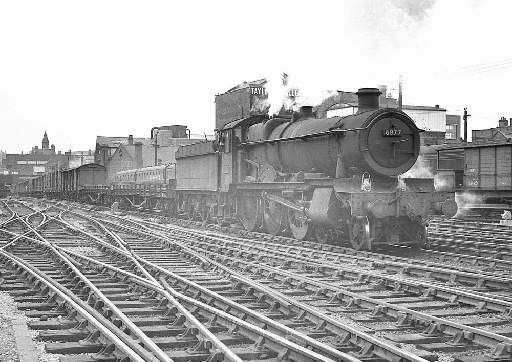 Ex-GWR 4-6-0 68xx class No 6877 'Llanfair Grange' passes through Snow Hill with an up freight on 17th April 1964