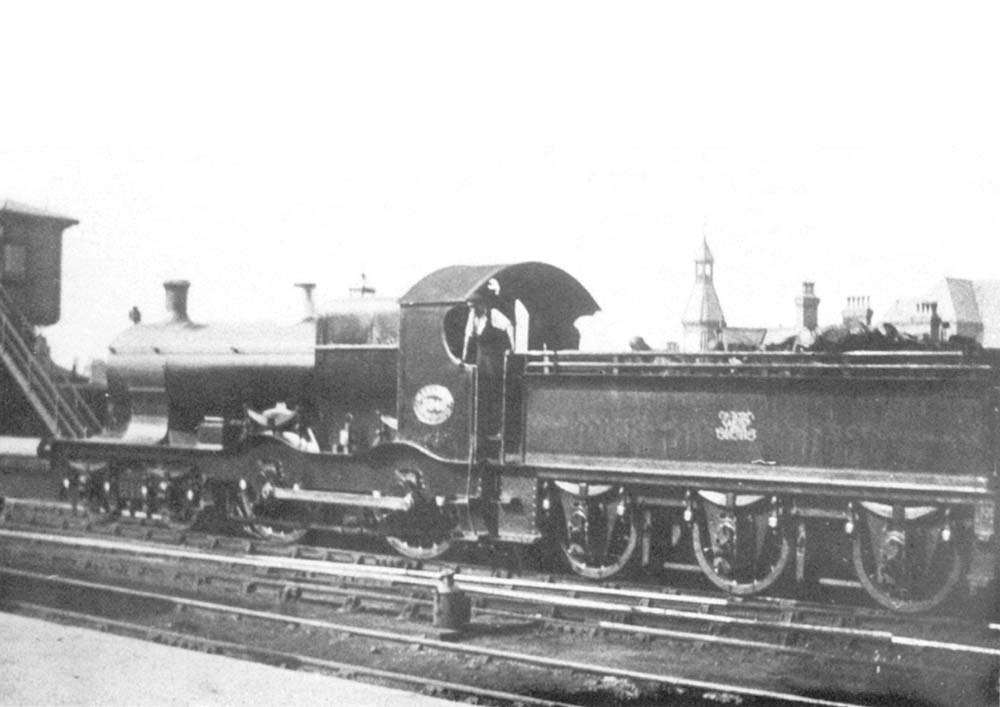 GWR 4-4-0 Bulldog class No 3340 Marazion is seen standing at the North end of the up platform with the North Signal Box seen on the left