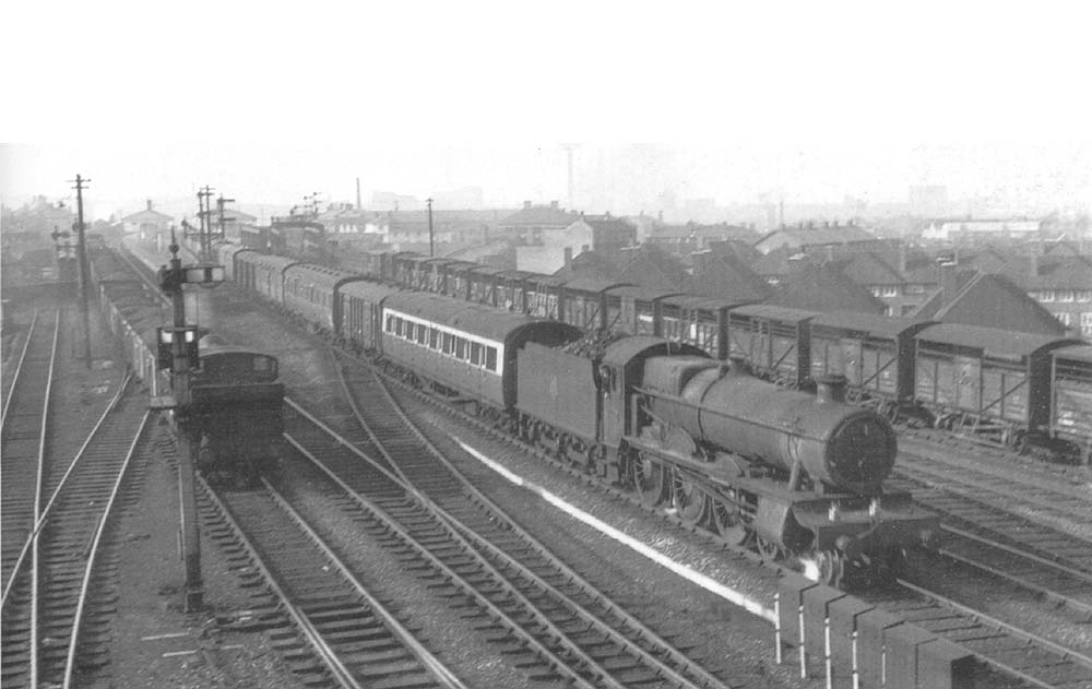 An unidentified ex-GWR 4-6-0 Hall class locomotive is seen on up express parcels service as it passes through the station