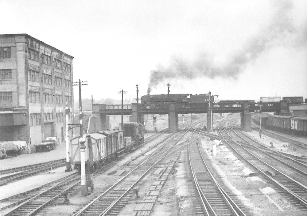 Looking north from Bordesley South Signal Box as a class 9F 2-10-0 crosses the ex Midland Railway viaduct with a freight on 31st�August 1957