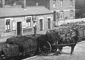 Close up of the unloading of manure from a GW open wagon on to a two wheel cart on the wharf