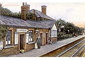 View of Claverdon station with the Station master standing under one of the station oil lamps