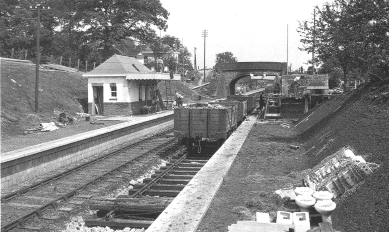 View tshowing the road-side booking office complete whilst work has started on the new footbridge in front of the road bridge