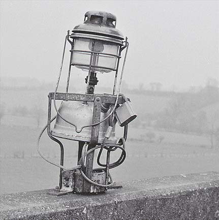 A photograph of the Tilley Lamp located on the concrete footbridge at Danzey for Tanworth station in the mid-1960s
