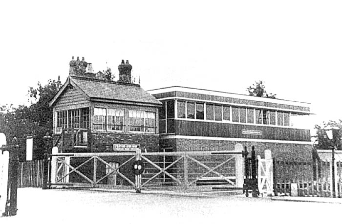 The original 1891 signalbox stands sandwiched between the gates controlling Evesham Rd and its replacement