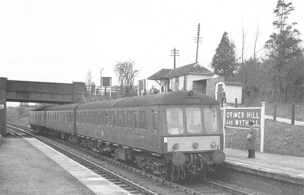 A Derby built three-car Diesel Multiple Unit is seen arriving at Grimes Hill & Wythall station on the 10 35am Stratford upon Avon to Snow Hill service