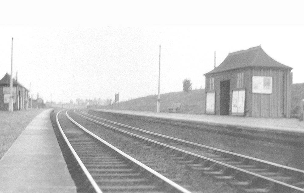Looking towards Birmingham in the late 1930s with a train in the distance about to arrive at the up platform on the right