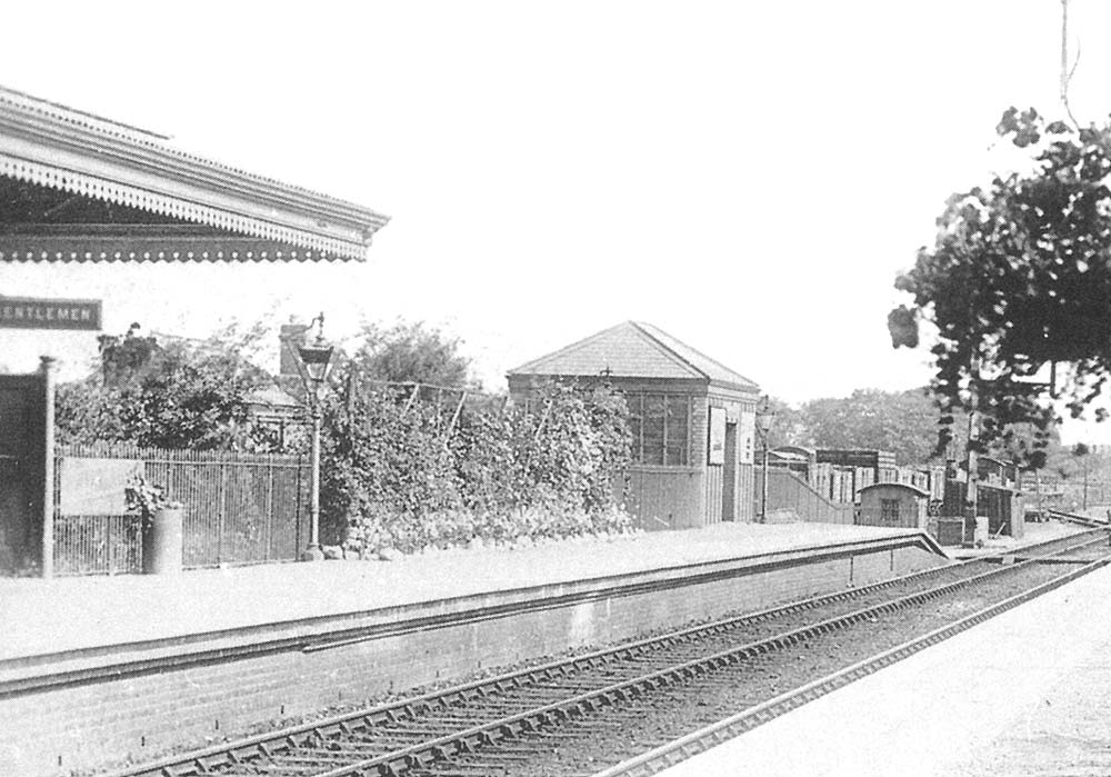 Close up showing the up platform showing the goods lock up shed behind the shubbery and the permanent way workers mess hut and store