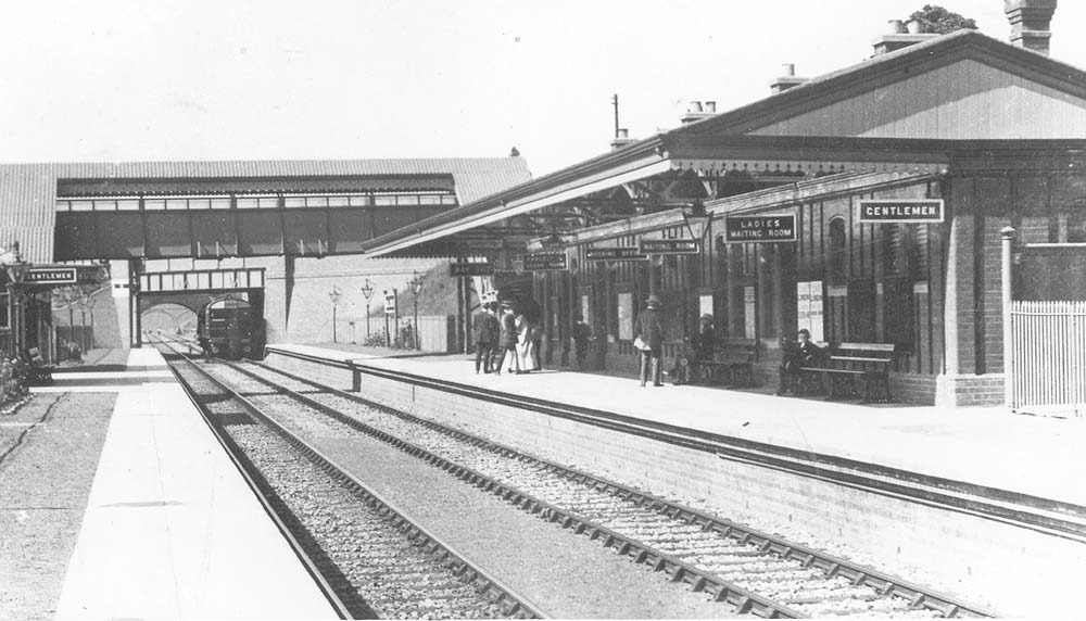 Looking towards Stratford upon Avon as a Steam Rail car passes underneath the Stratford Road bridge to enter the station