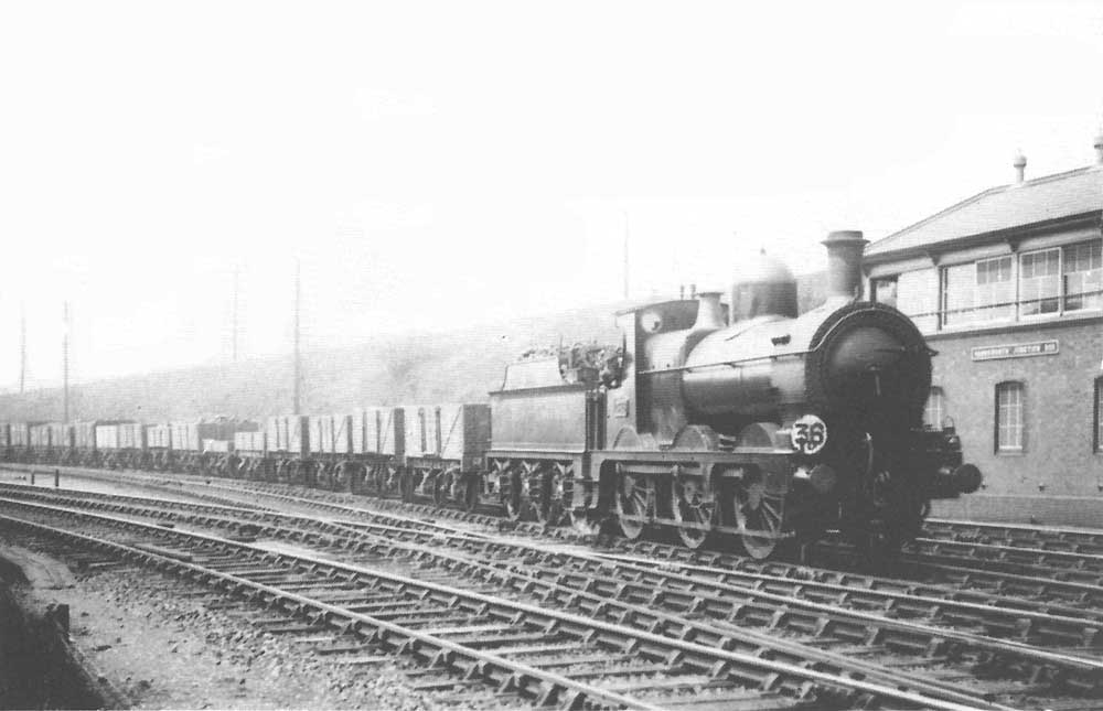 An unidentified GWR 0-6-0 Goods locomotive is seen passing Handsworth Junction Signal Box whilst at the head of long goods train