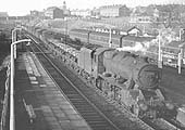 Ex-LMS Stanier 8F 2-8-0 No 48543 is seen passing through the station whilst at the head of an up freight on 31st December 1964