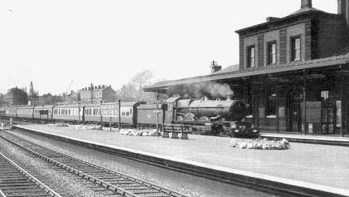 Looking towards Wolverhampton as an unidentified ex-GWR 4-6-0 Castle class locomotive heads an up express through the station