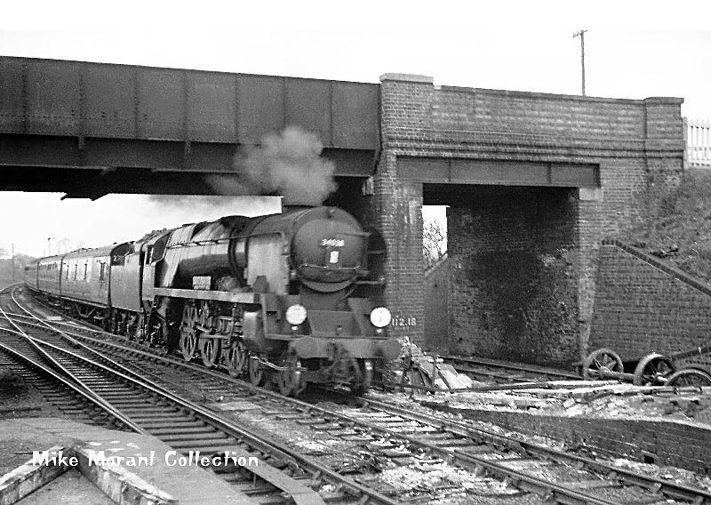 Ex-Southern railway 4-6-2 No 34028 passes under the road bridge returning from Birmingham with the FA Cup supporters