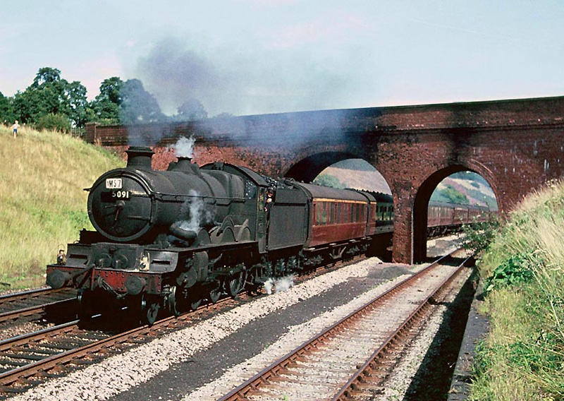 Ex-GWR 4-6-0 Castle class No 5091 'Cleeve Abbey' is seen nearing the summit at the head of a down express service from Paddington