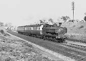 Ex-Great Western Railway 0-6-0T 57xx class No 7702 on the down main line with a Leamington to Stratford local on 6th May 1953