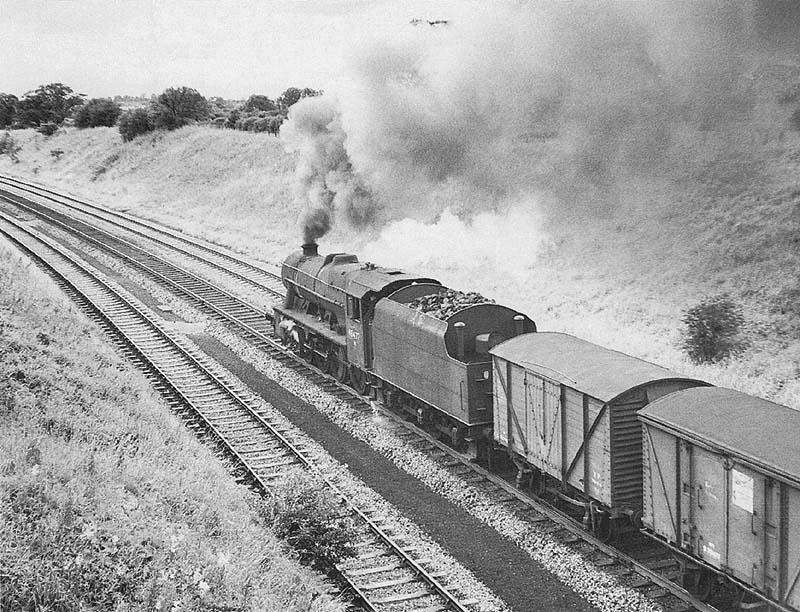 Ex-LMS 8F 2-8-0 No 48477 is seen working hard as it heads a down freight on 26th July 1966