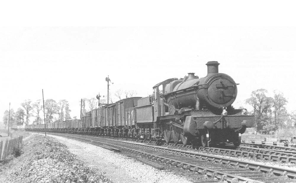 Ex-GWR 4-6-0 Grange class No 6844 'Penhydd Grange' is seen near Henley-in-Arden whilst at the head of a down freight in March 1950