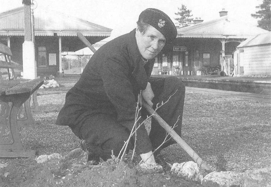 A pose view of Betty Castle who is seen preparing one of the many flower beds during the spring months in the 1950s