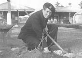 A pose view of Betty Castle who is seen preparing one of the many flower beds during the spring months in the 1950s