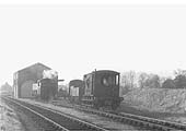 Ex-GWR 0-6-0PT 94xx class No 9432 is seen with its wagons rolling past, by gravity, into a parallel siding