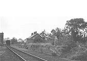 A general view of Henley-in-Arden's original passenger station showing TR Perkins standing on the derelict platform in August 1939