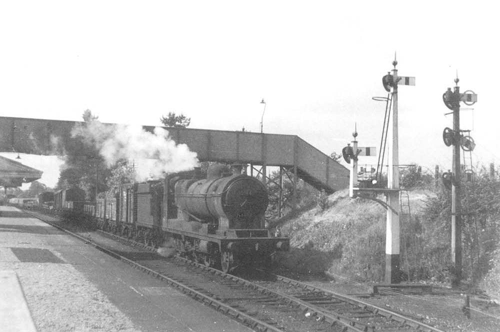 Ex-Railway Operating Department 2-8-0 No 3044 is seen passing through the station whilst at the head of a northbound freight