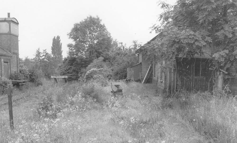 View looking along the platform of Henley-in-Arden's original station showing much neglect and over growth since the 1940s views