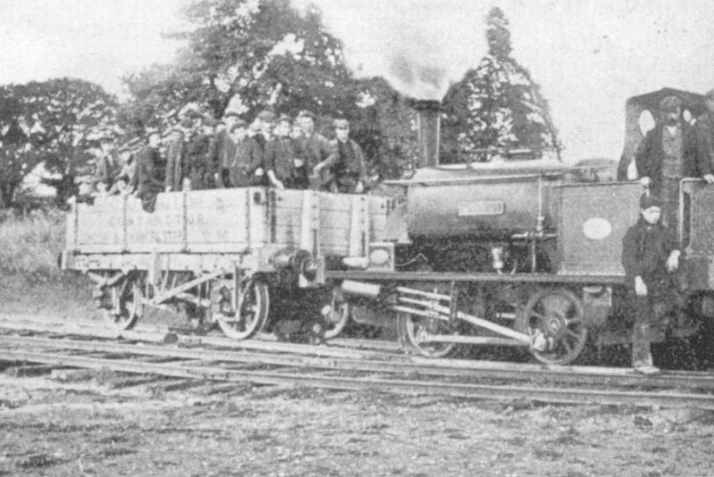 A contractor's train consisting of one open wagon carry a crew of approximately forty men poses for the camera