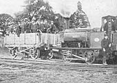 A contractor's train consisting of one open wagon carry a crew of approximately forty men poses for the camera