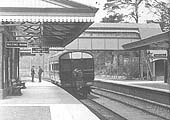 Close up showing the single unit railcar standing at Henley-in-Arden's up through platform and the island platform's passenger building