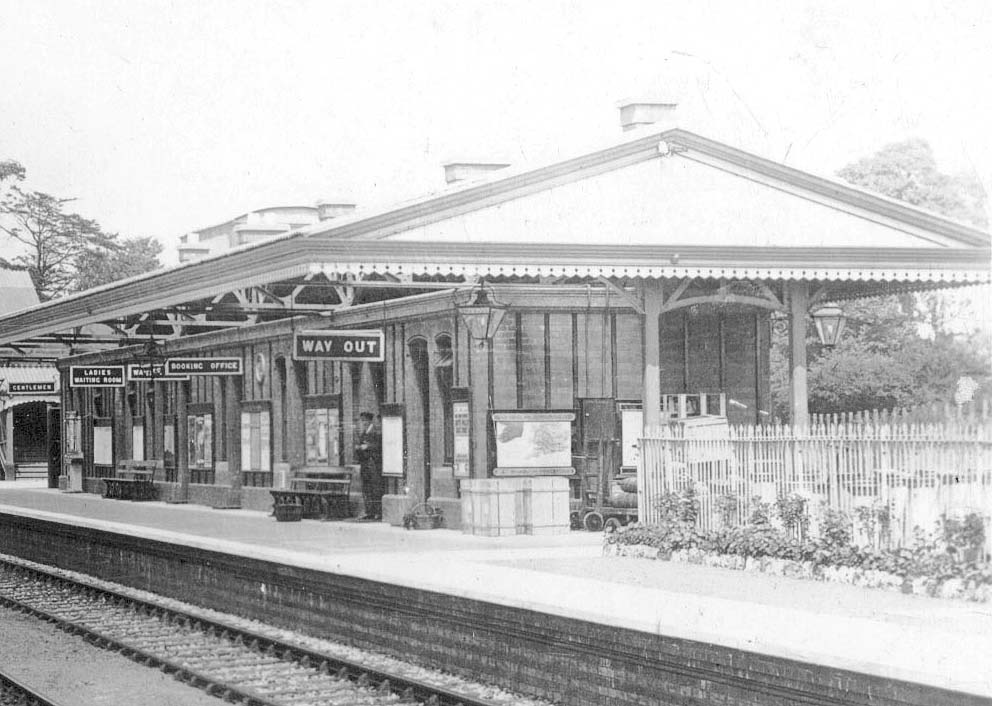 Close up showing the down platform building and the array of signs suspended beneath the canopy for the comprehensive facilities available