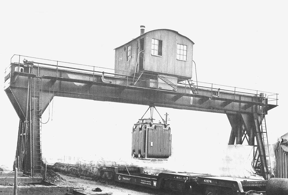 The 25 ton Goliath travelling gantry crane at Hockley Goods Yard unloading a transformer from bogie boiler trolley